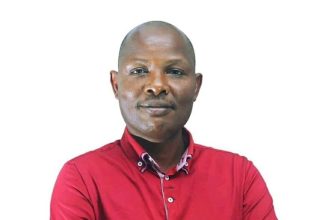 Charles Rwomushana, Ugandan politician and former ISO research head, in an official portrait wearing a red shirt