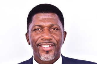 Balimwezo Ronald Nsubuga, Ugandan MP for Nakawa East and Chairperson of Kampala City Roads Committee, in a formal suit
